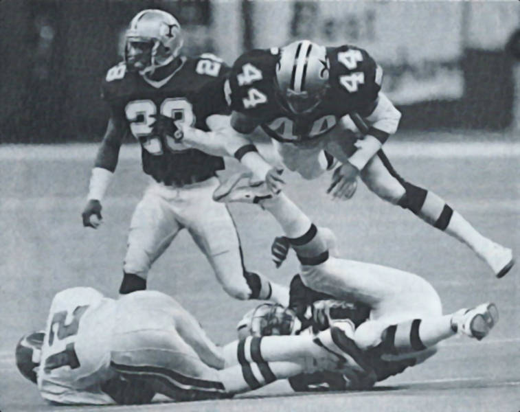 Randal Cunningham is stopped by New Orleans Saints defenders Sam Mills, Dave Waymer and Gene Atkins